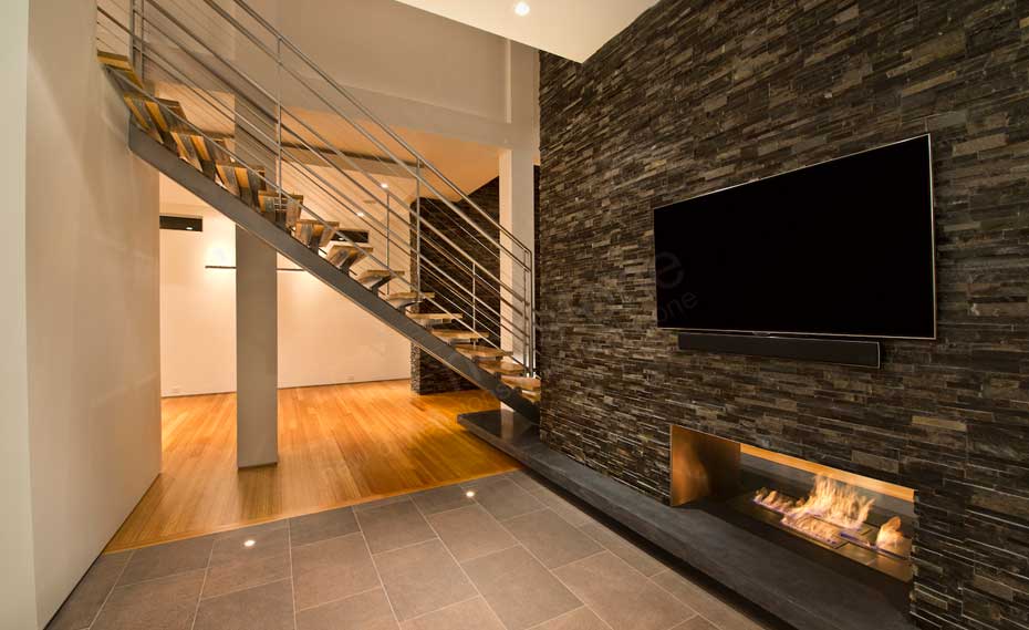Natural Stacked Stone Veneer Wall Cladding on Interior Wall with TV and a fireplace