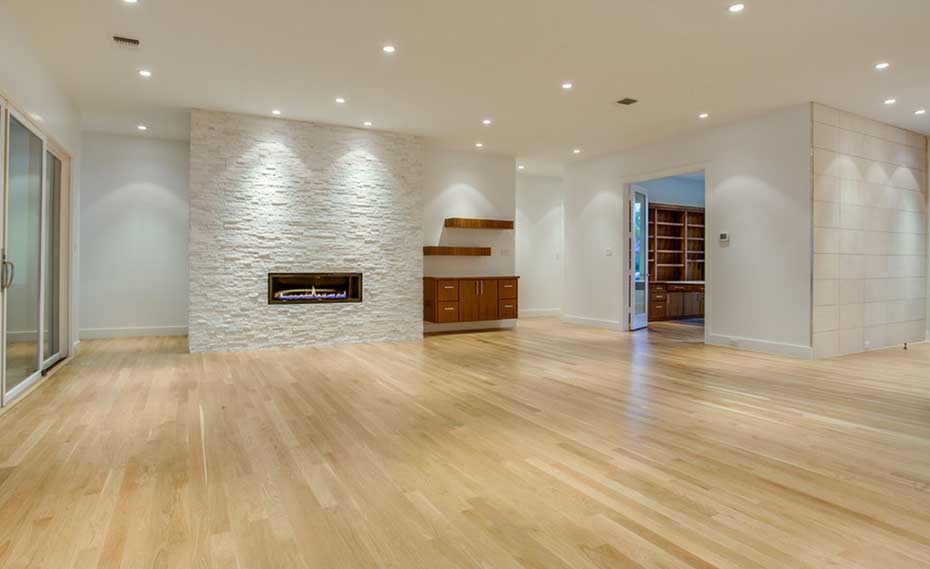 White Quartz Stone Fireplace in living room with wood floors in Dallas Texas