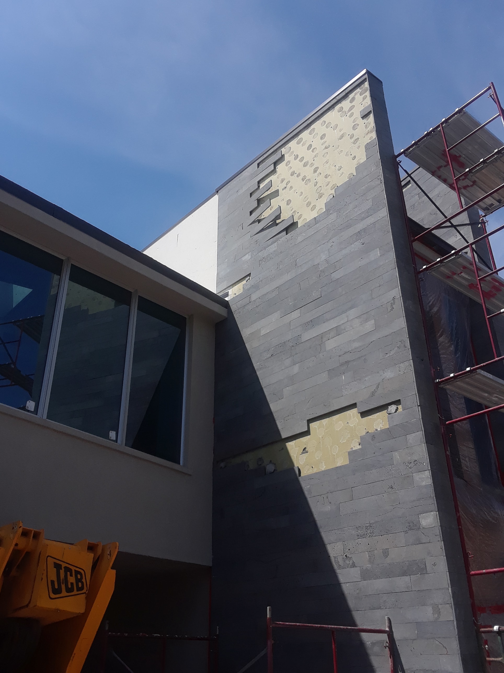 Technical article about how spot bonding stone veneer installations can result in failure and stone falling off the wall