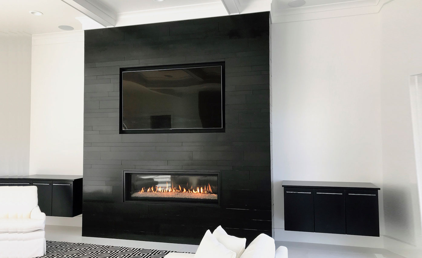 Gorgeous smooth black fireplace stone veneer by Norstone on a residential fireplace in Charlotte North Carolina