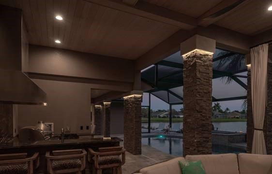 Norstone Charcoal XL Stacked Stone Panels on columns surrounding a pool and patio area