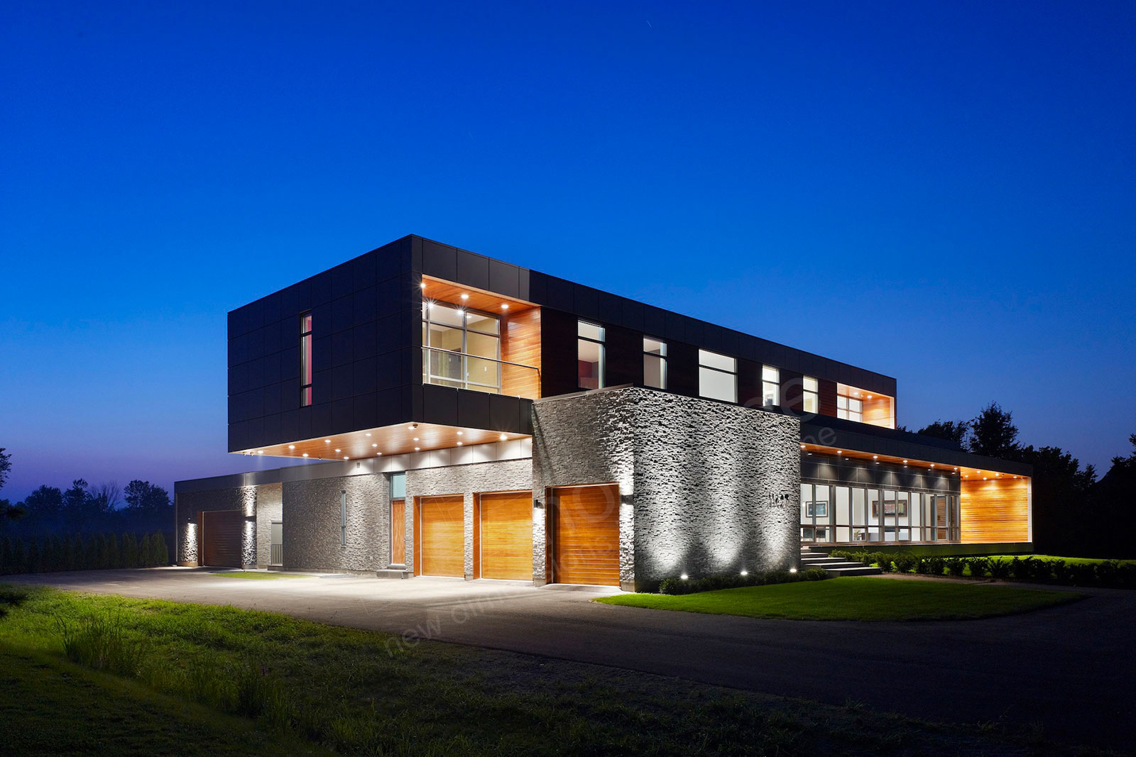 Contemporary Box Design Home with textured grey stone veneer facade