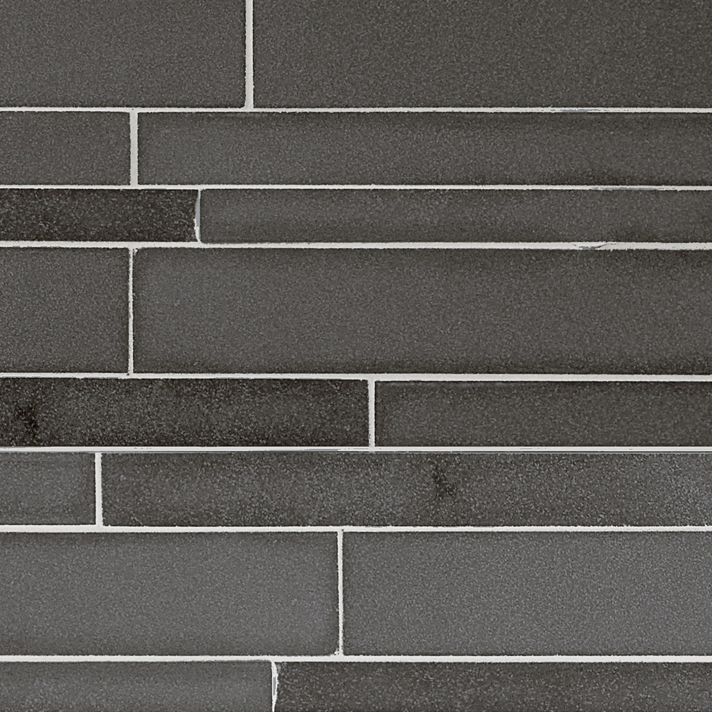 A close-up view of a gray stacked stone wall with horizontal rectangular tiles of varying lengths arranged in a staggered pattern, showcasing a high end stone design.