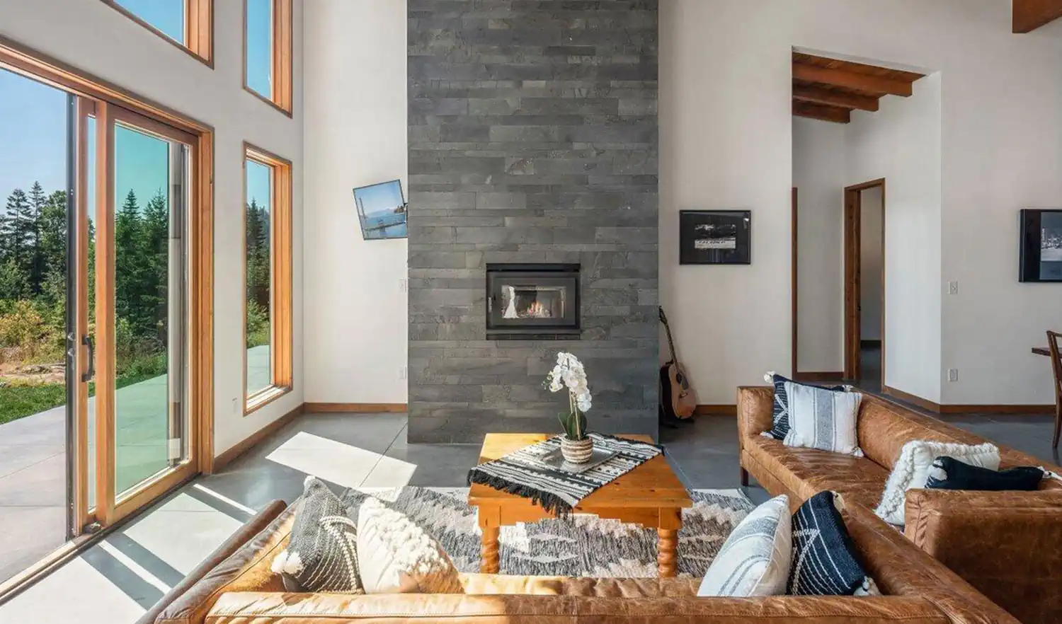 Norstone Graphite Planc large format tiles on a two story residential fireplace with a wood burning insert.