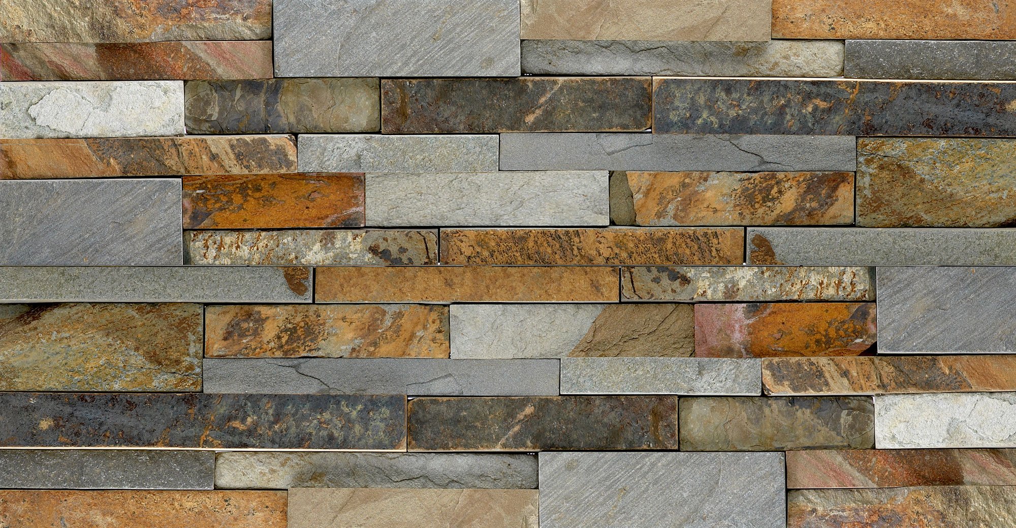 A close-up view of a wall made of natural stone veneer bricks in earthy tones like brown, gray, and rust, arranged in a staggered horizontal pattern for a high end stone design.