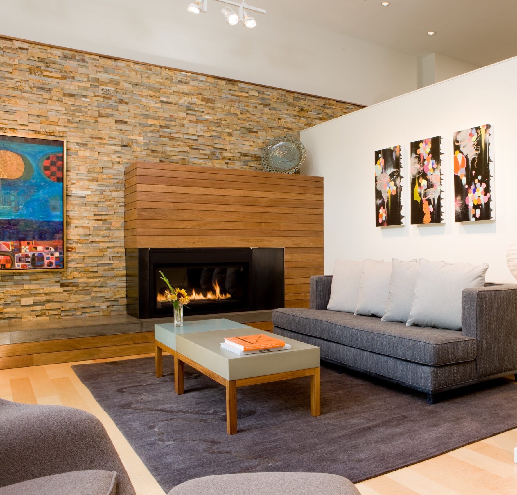 Ochre blend stacked stone rock panels used as a warm and beautiful backdrop accent wall to a modern living room